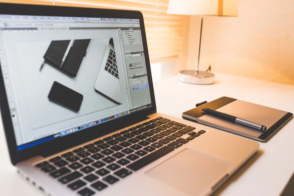 A clean, minimal desk arrangement with dual monitors, a keyboard, mouse, and notebook designed for productivity.